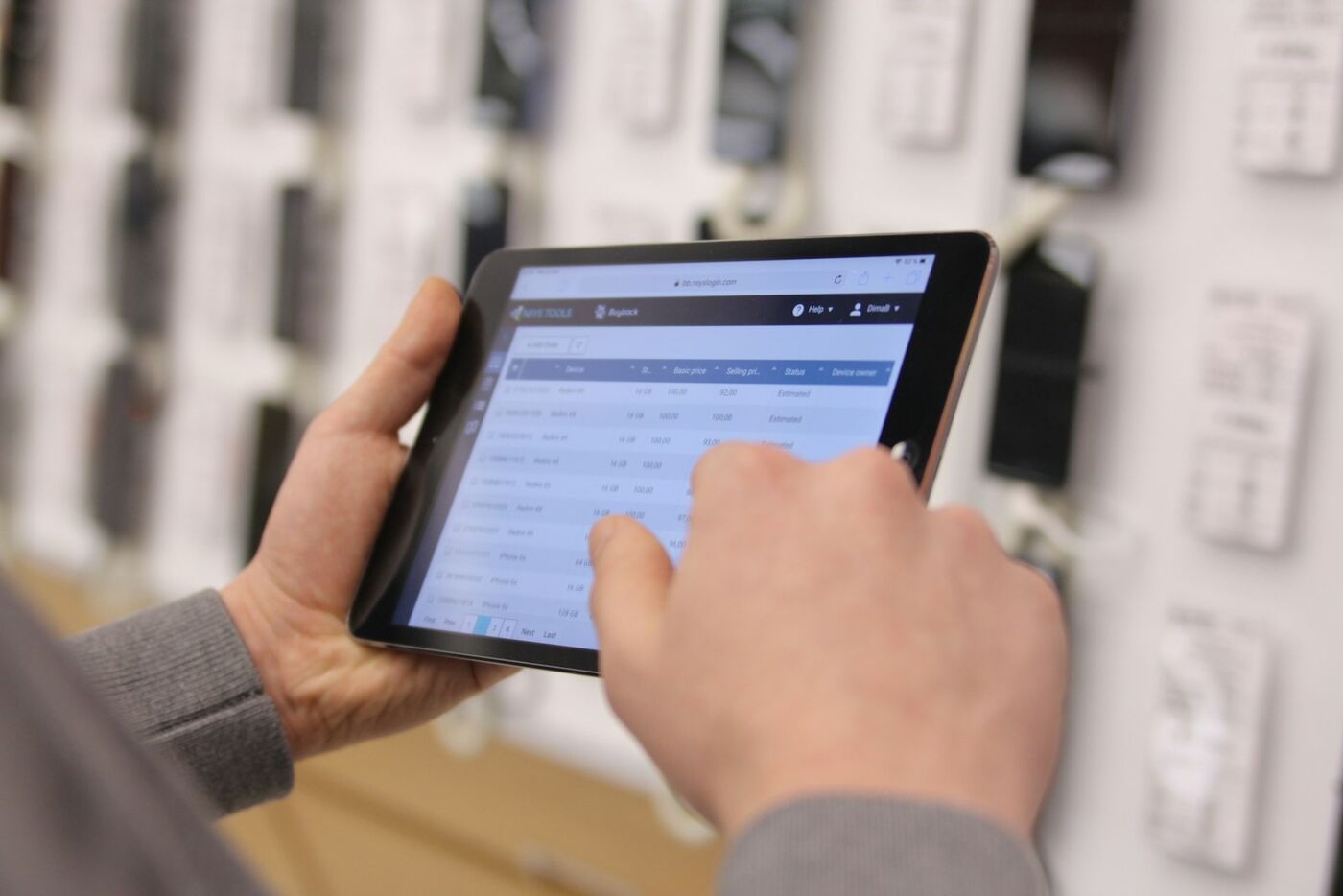 A member of staff working through a job list on a tablet