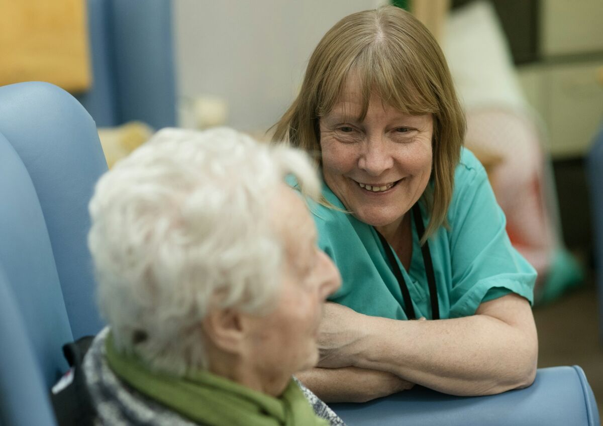 A carer talking with an elderly client